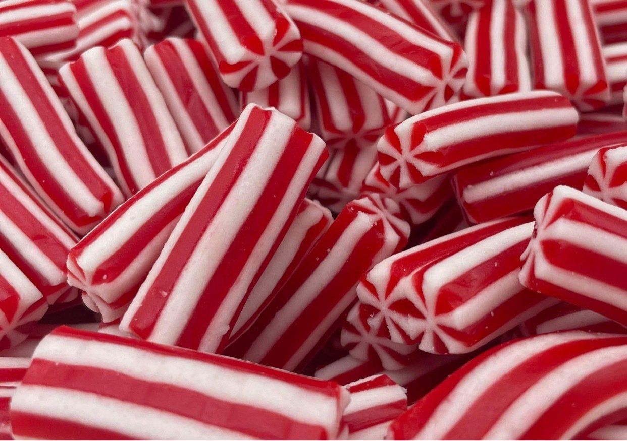 A pile of red and white striped candy sticks