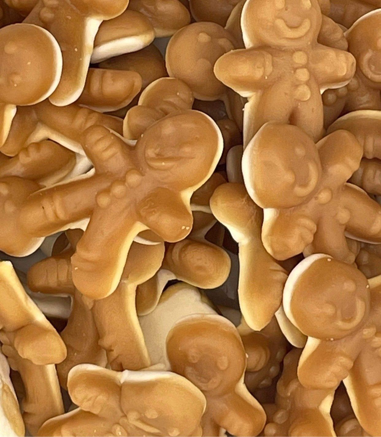 A pile of gingerbread men are stacked on top of each other