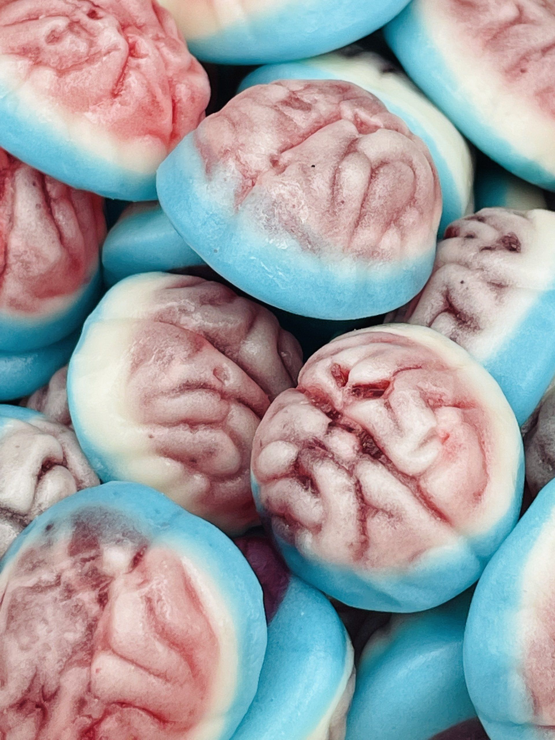 A pile of blue and pink brain shaped candies