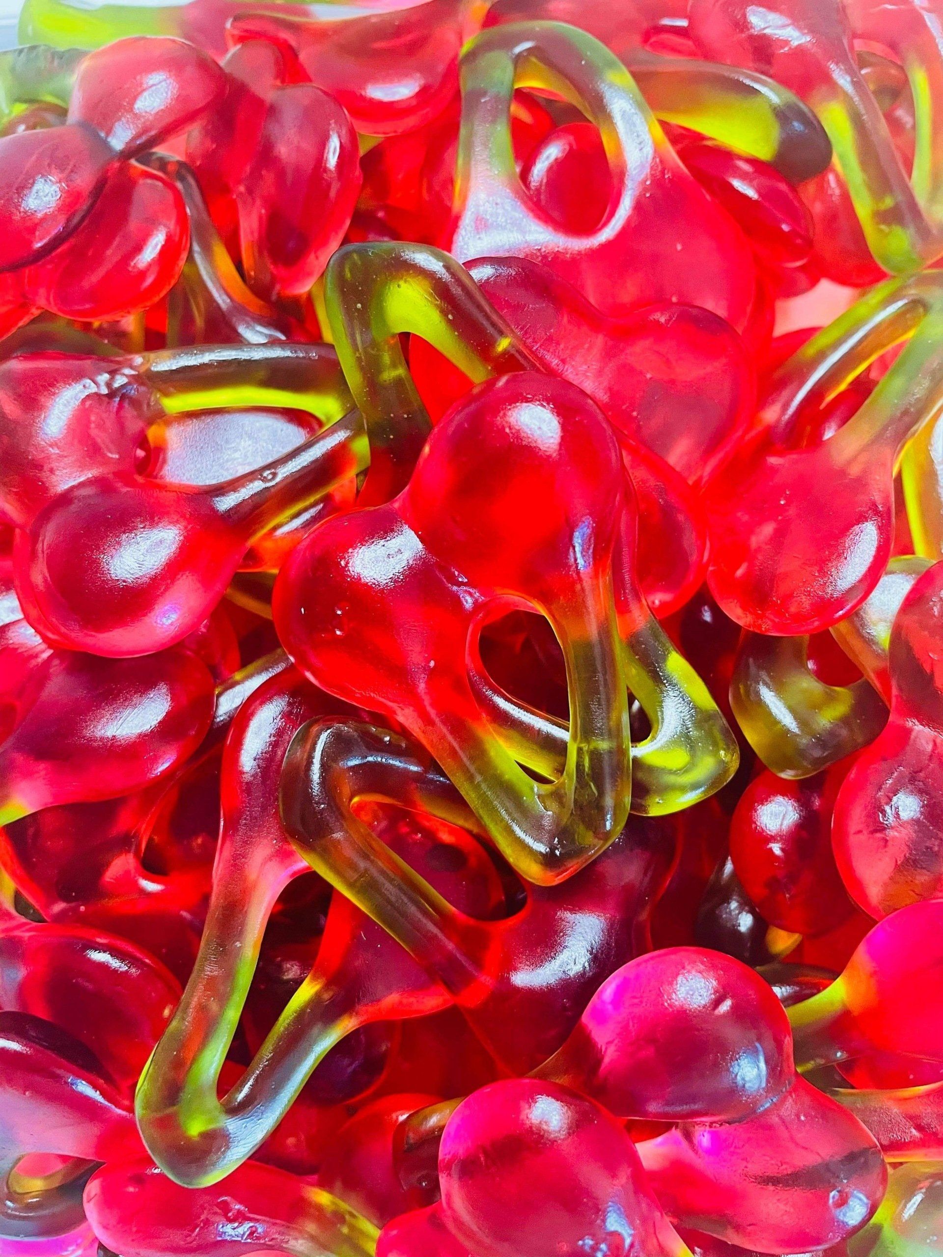 A close up of a pile of red gummy cherries