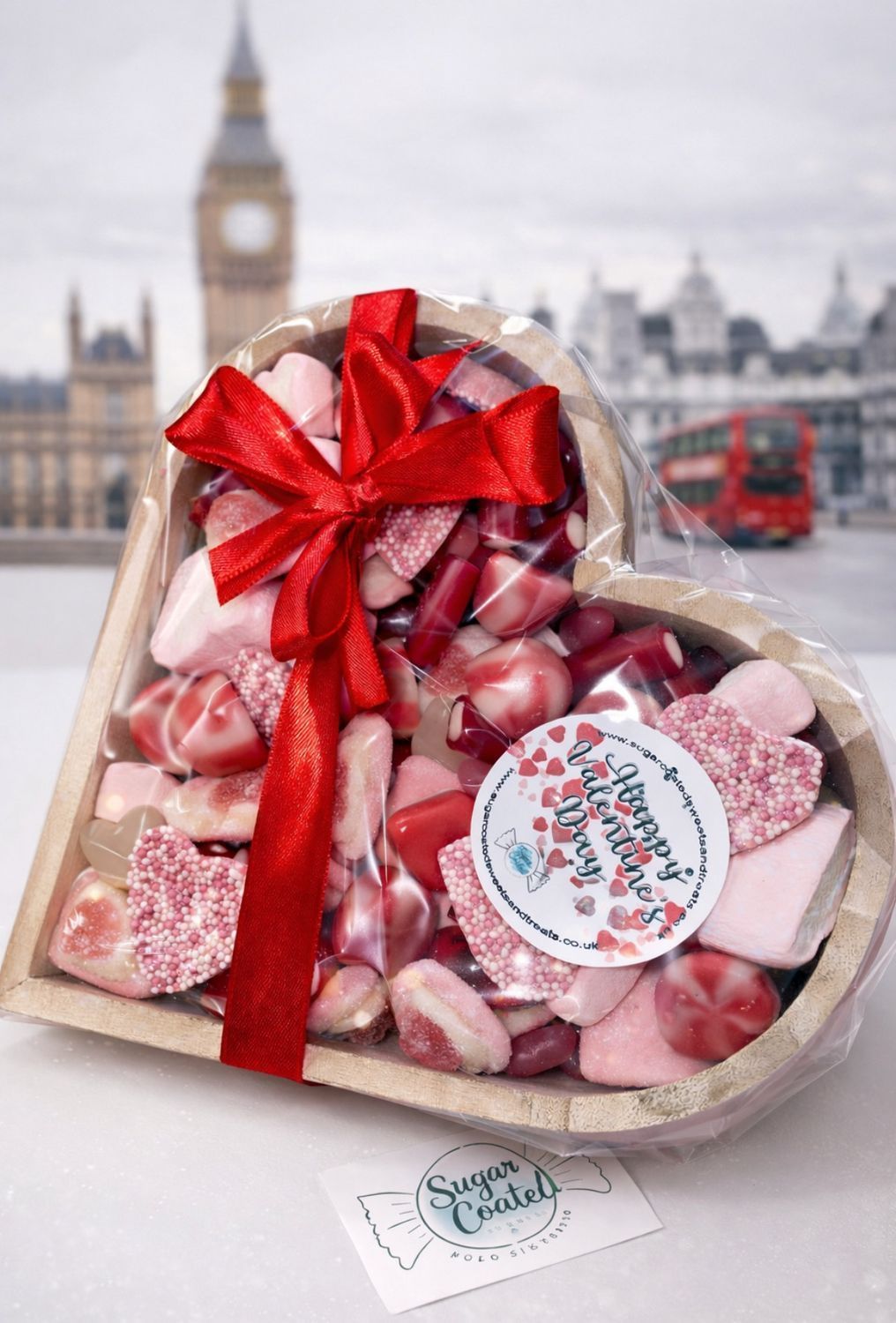 Valentine's Sweets in a wooden heart with an image of London and a red bus in the background