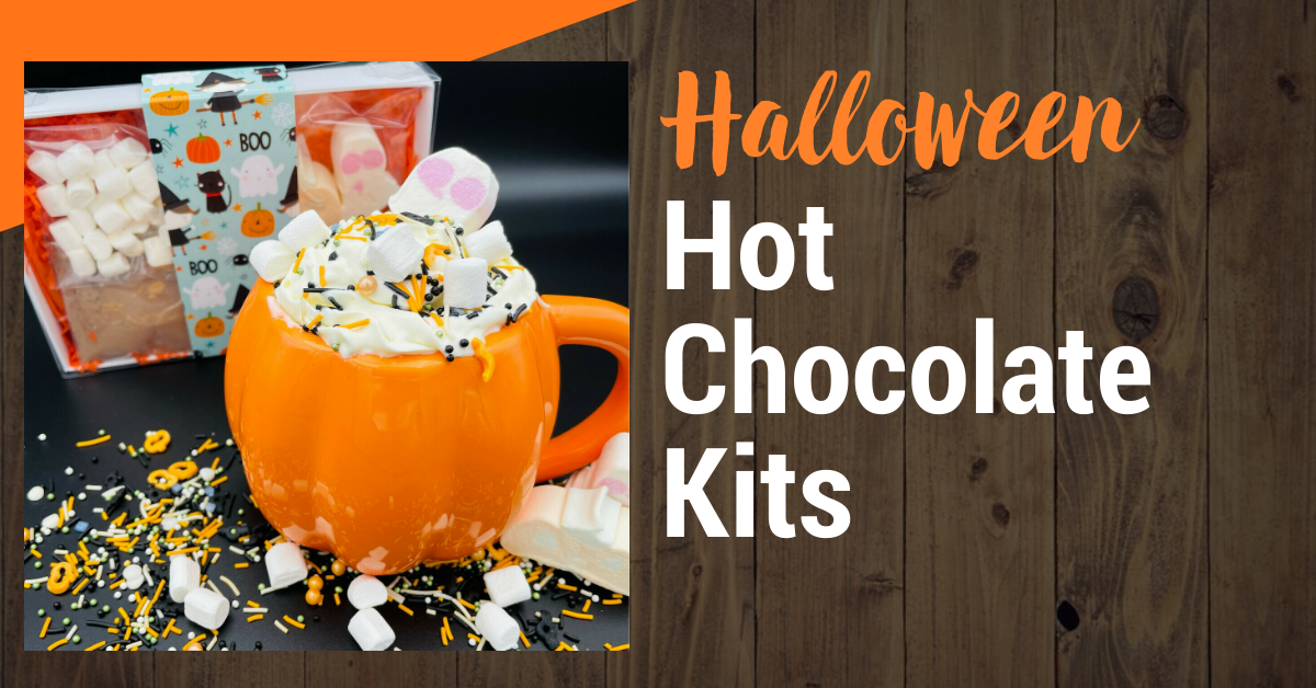 A pumpkin shaped mug filled with hot chocolate and marshmallows.