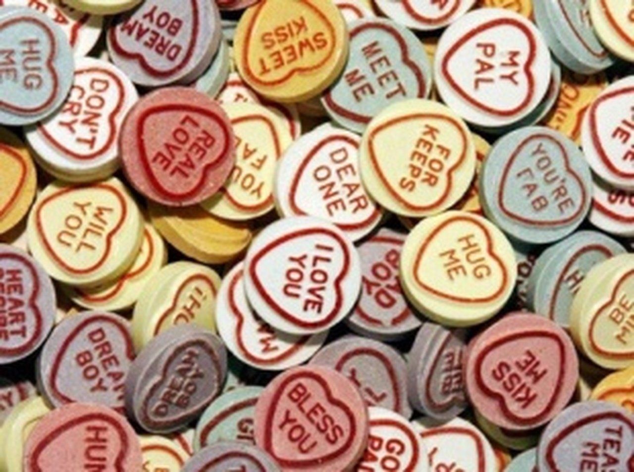 A pile of candy hearts that say i love you