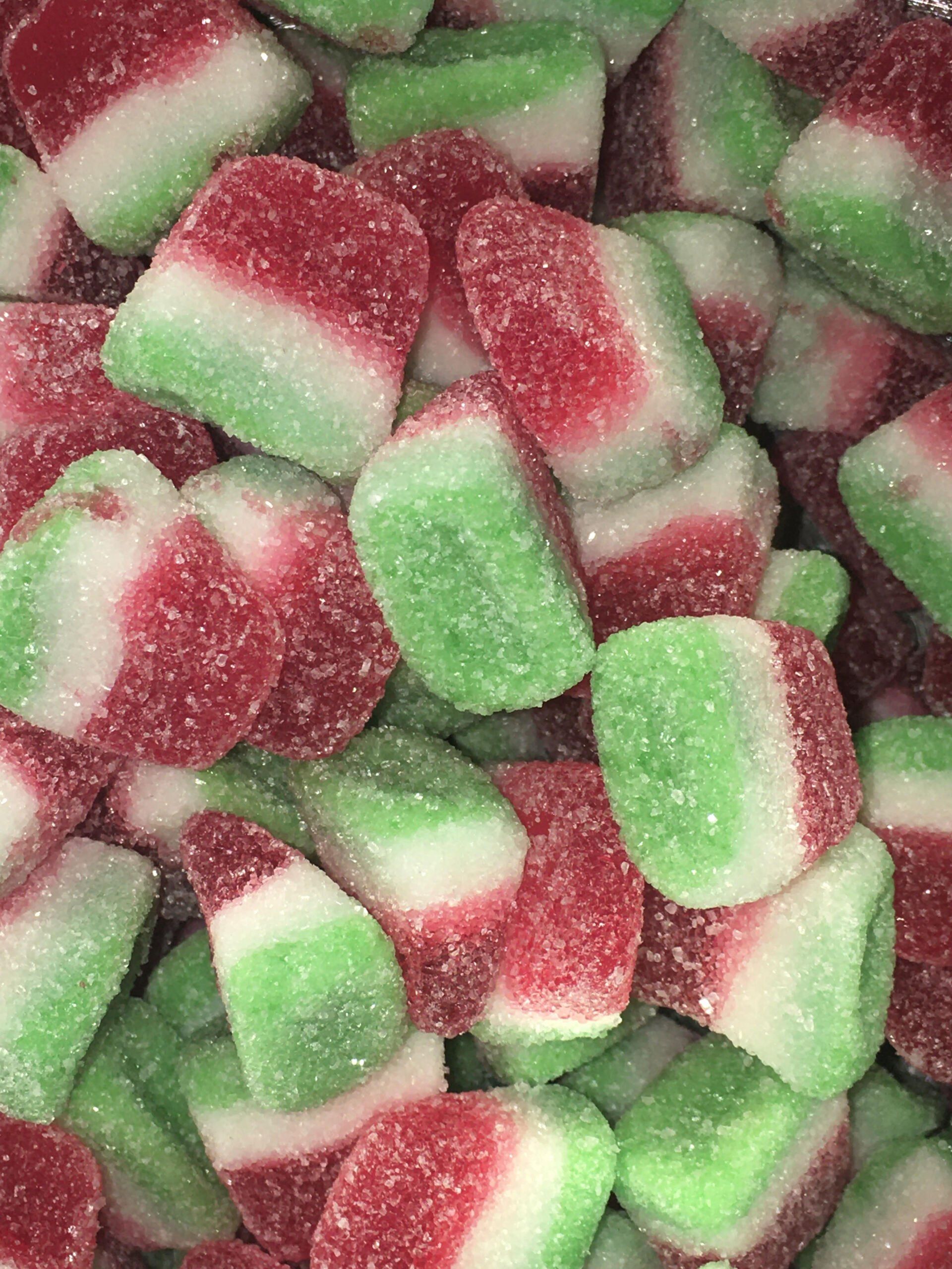 A pile of red and green watermelon shaped gummy candies.