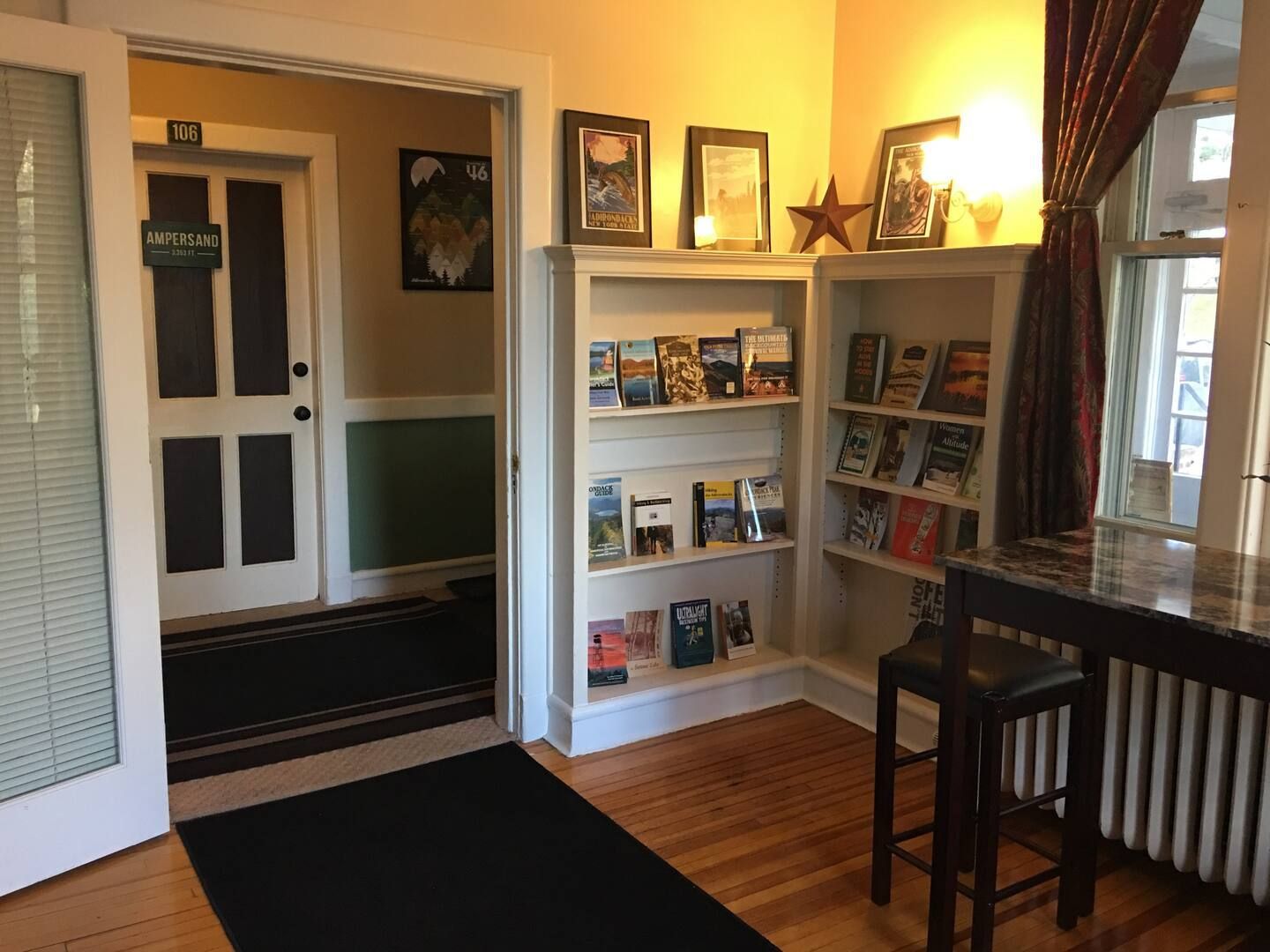 A bedroom with two beds and a lamp