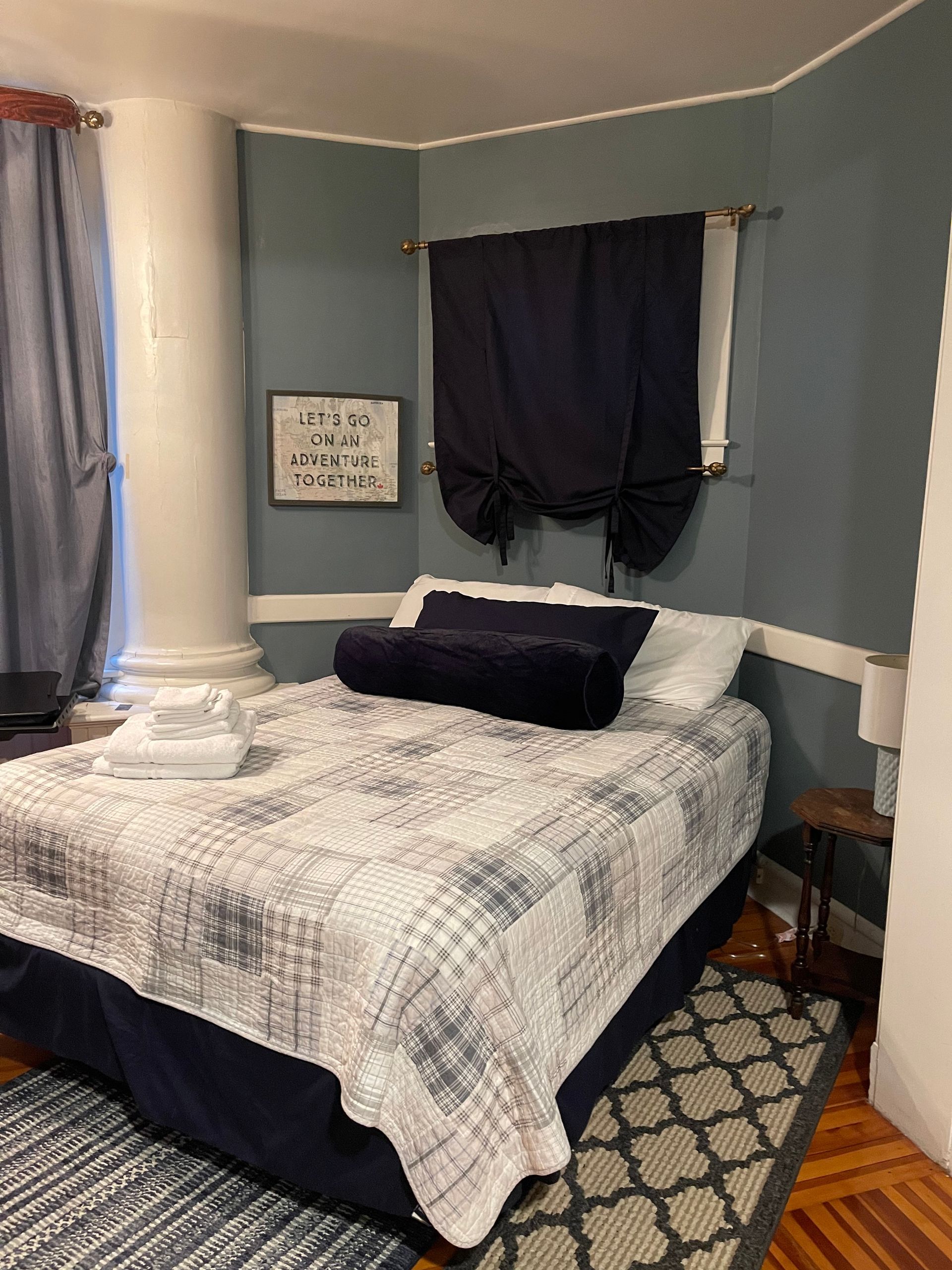 A bedroom with a king size bed and a mirror