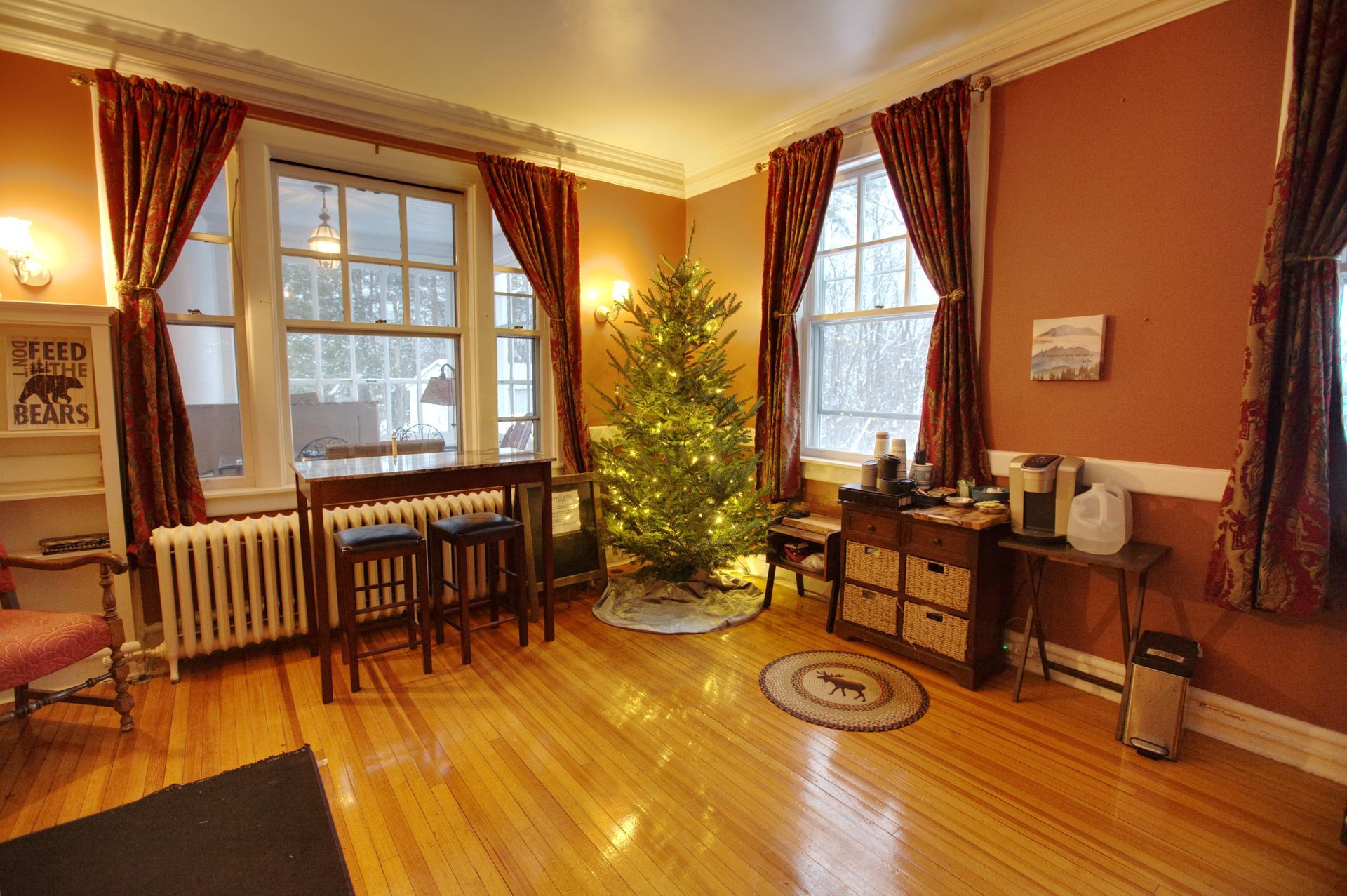 A living room with a christmas tree in the middle of it