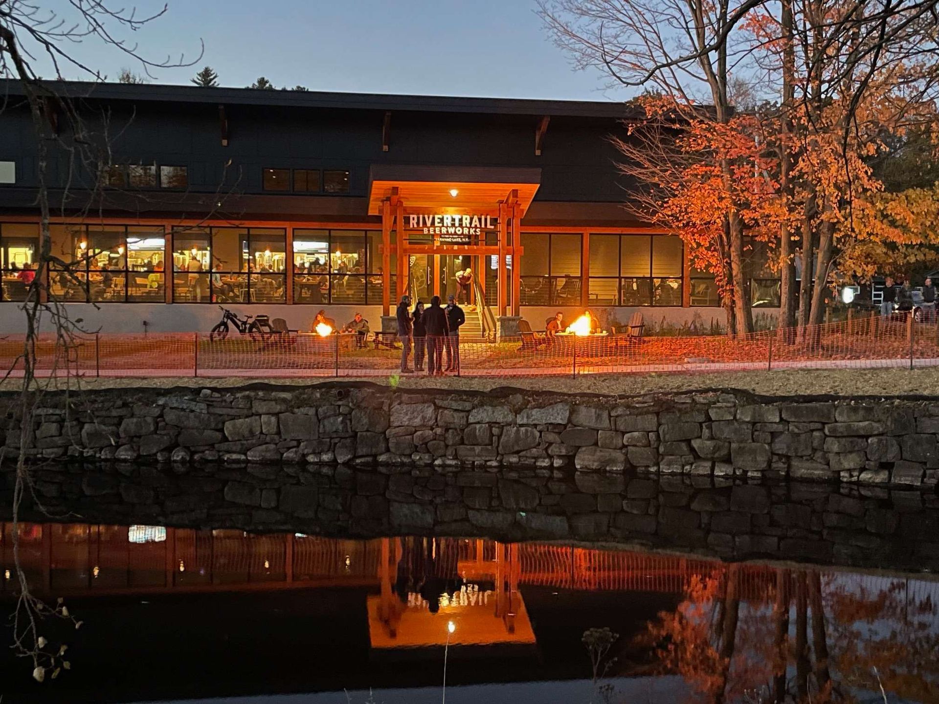 A large building with a pond in front of it