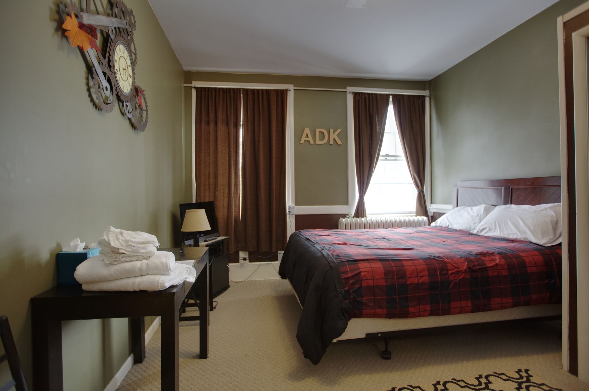 A bedroom with a bed and the word adk on the wall