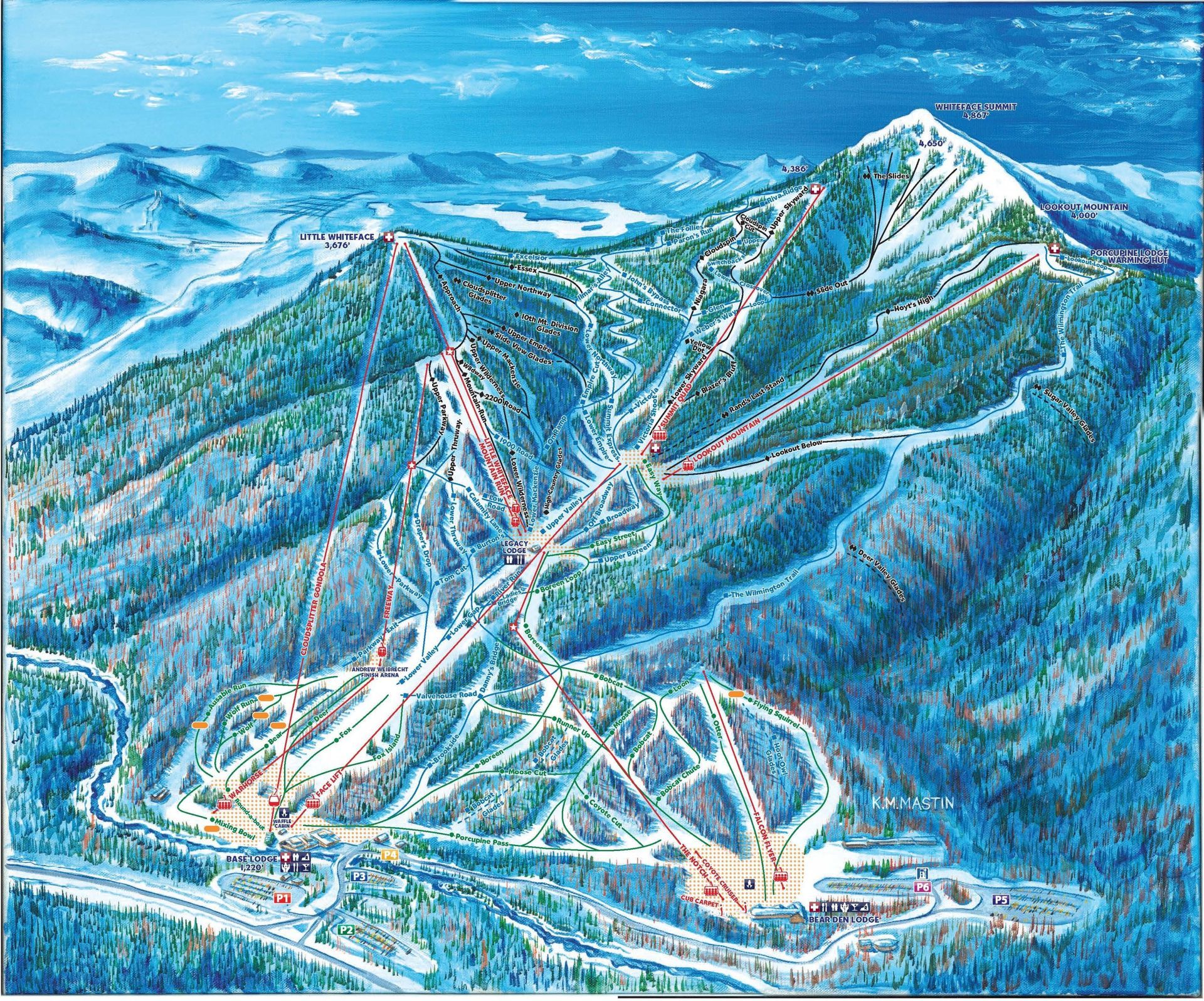 An aerial view of a ski resort with a mountain in the background
