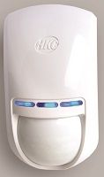 A white motion sensor is sitting on a white surface.