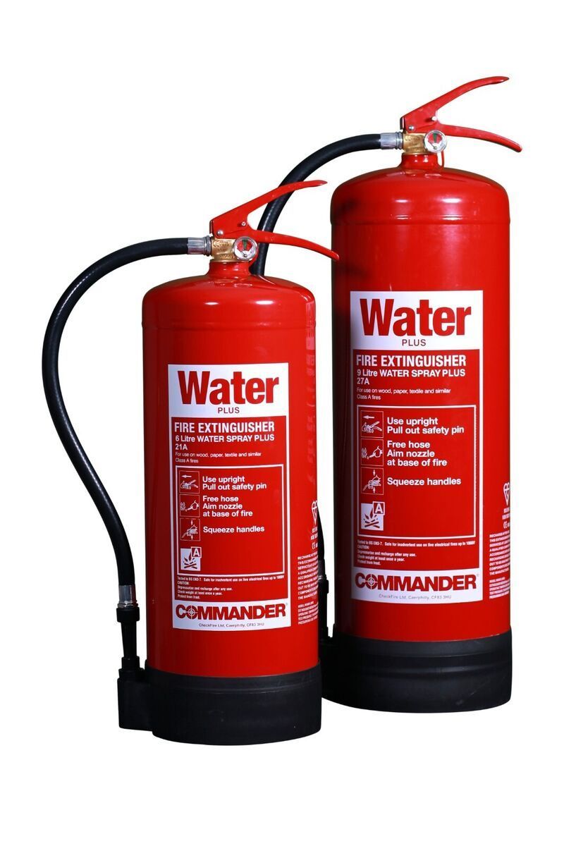 Two red water fire extinguishers are sitting next to each other on a white background.