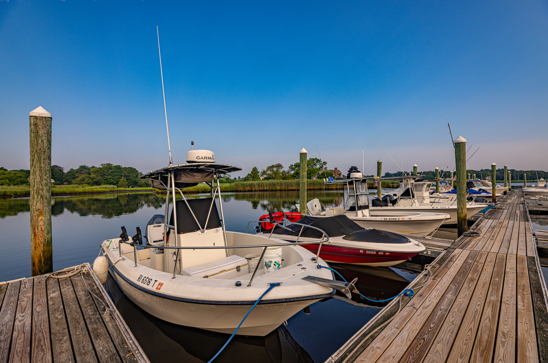 A boat is docked at a dock next to a body of water.