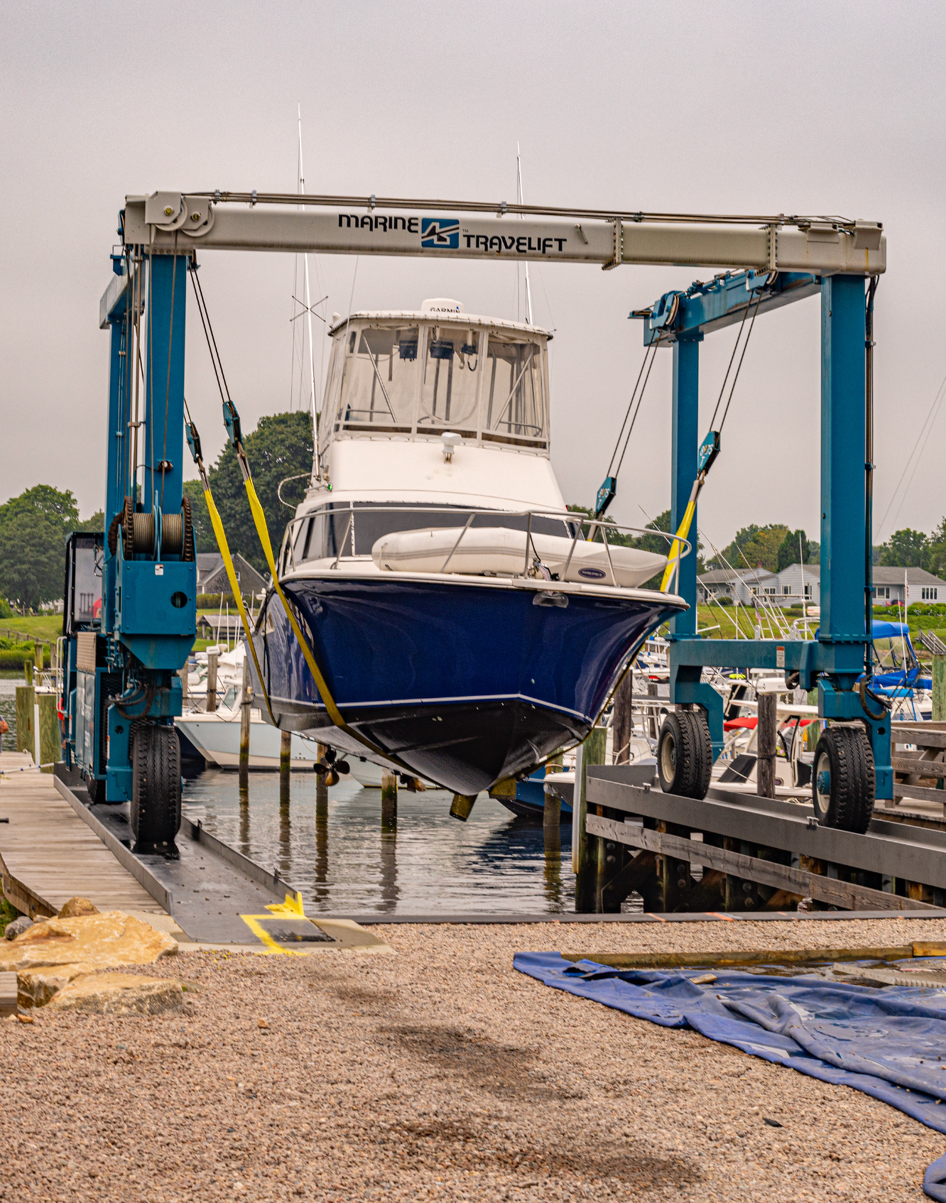 A boat is being lifted into the water by a crane.