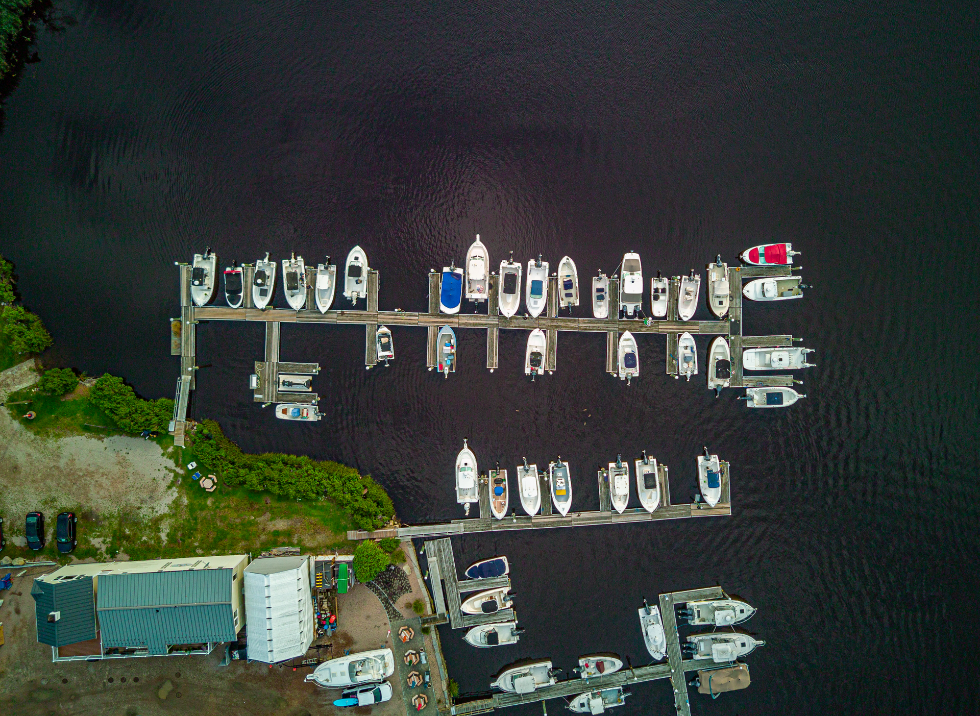 An aerial view of a marina with many boats docked