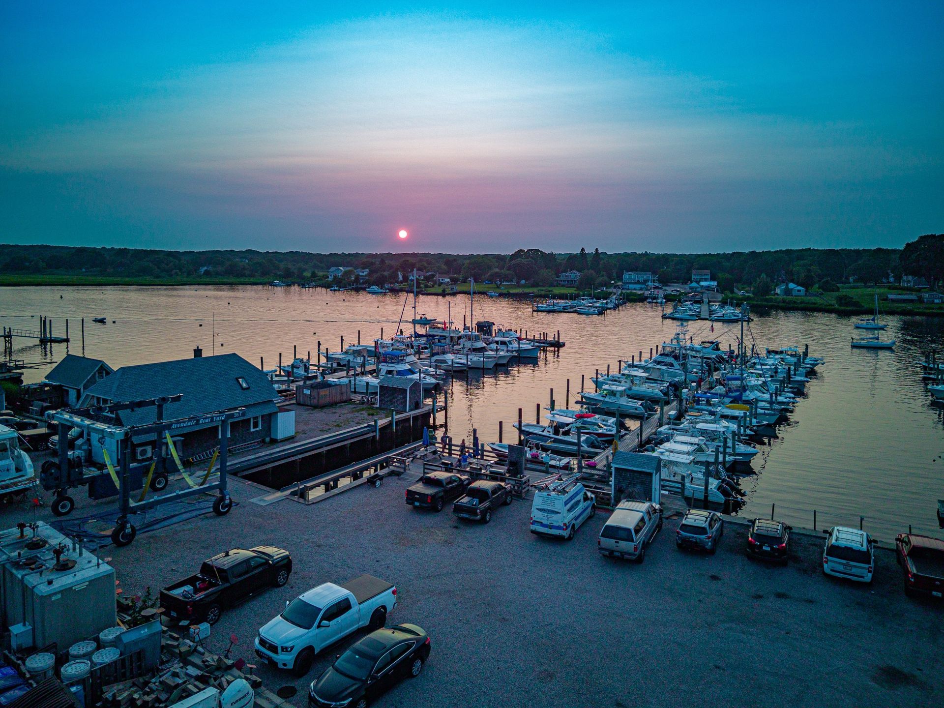 An aerial view of a marina with boats docked at sunset.