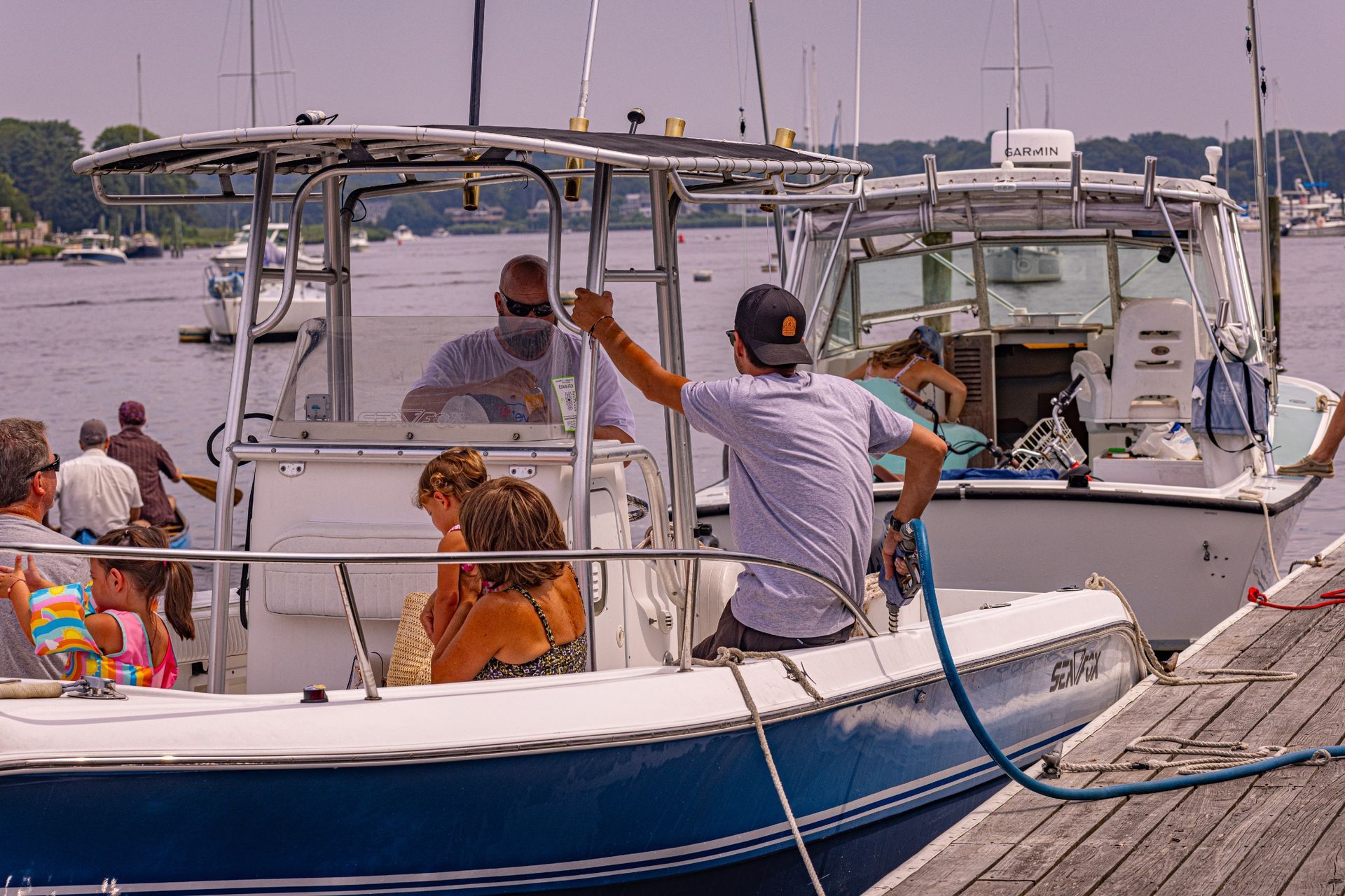 A group of people are sitting on a boat in the water.