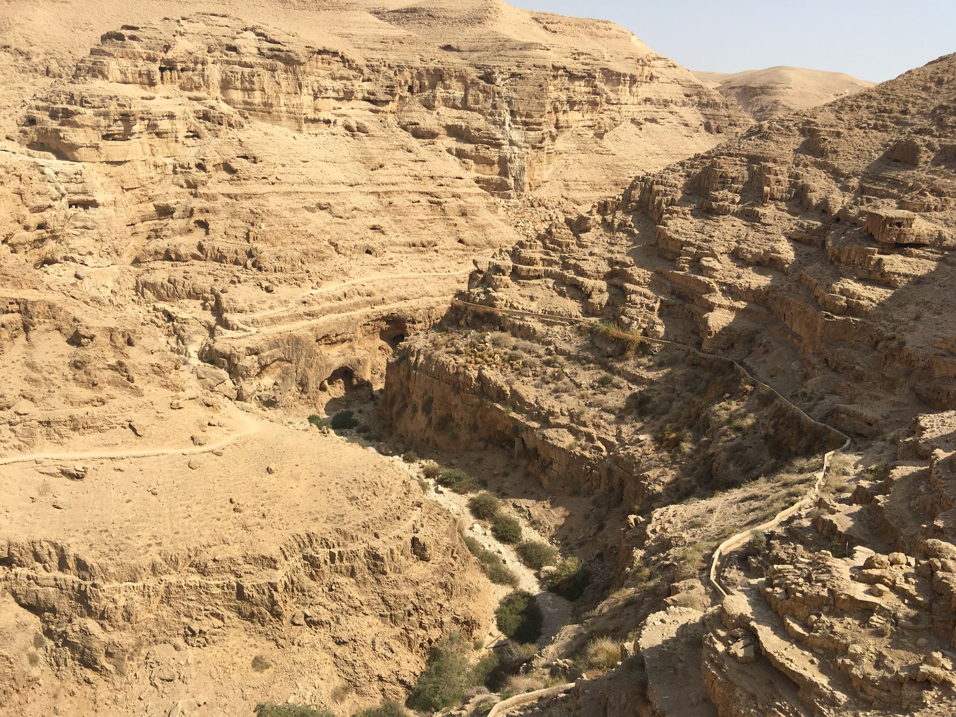A desert landscape with a river running through it