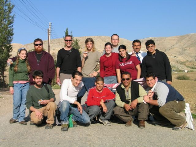 A group of people posing for a picture with one wearing a shirt that says fuel peak