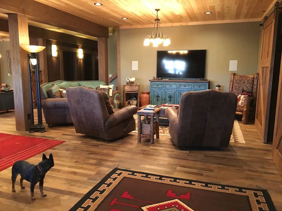 A dog is standing in the middle of a living room.