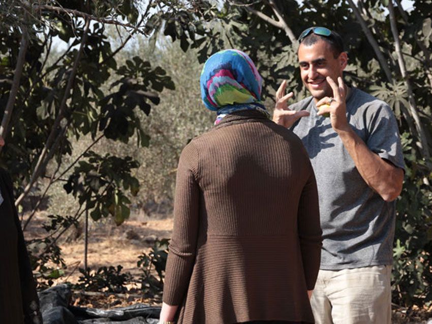 A man and a woman are talking in a field