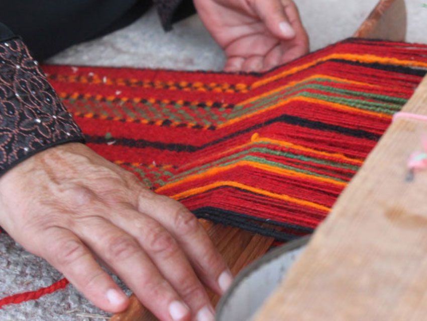A close up of a person 's hands holding a piece of fabric