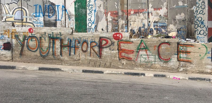 A wall with graffiti on it that says youth for peace