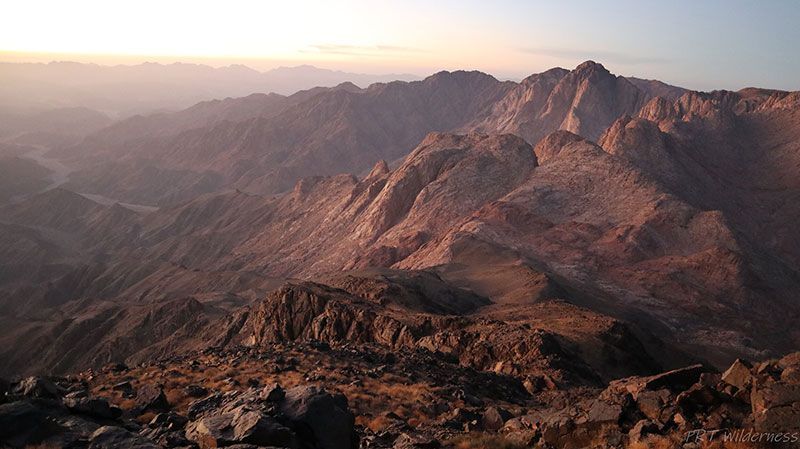 A view of a mountain range from the top of a mountain.