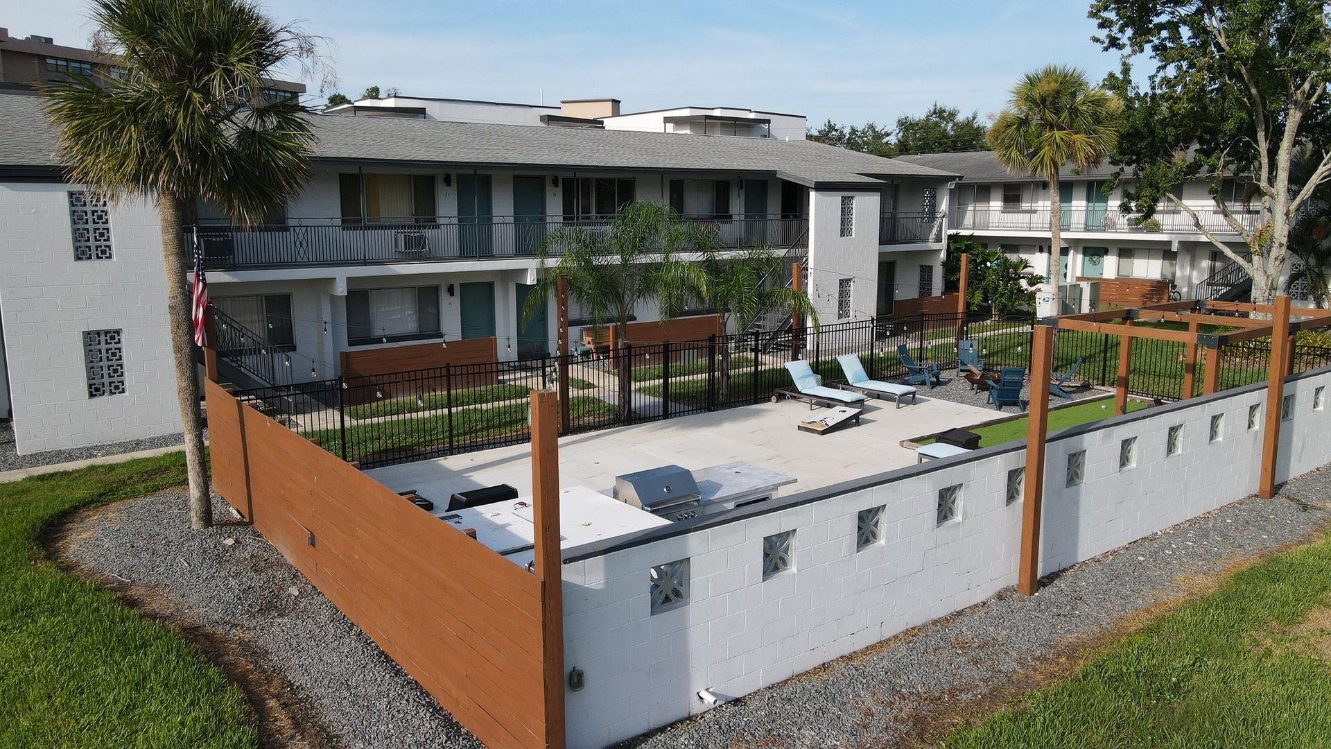 A large apartment building with outdoor common space.
