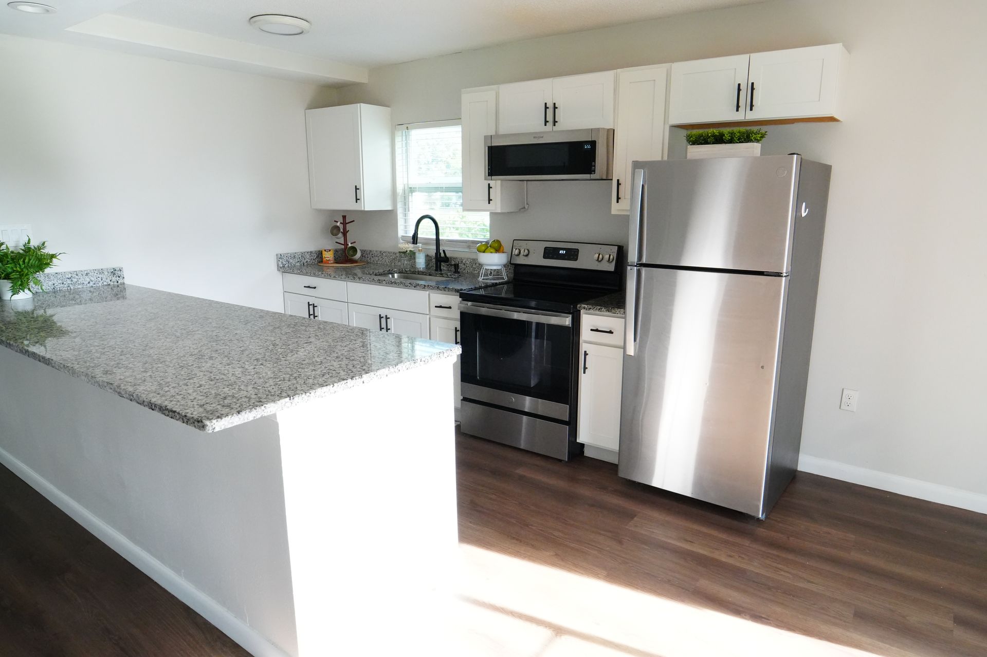 A kitchen with stainless steel appliances and granite counter tops