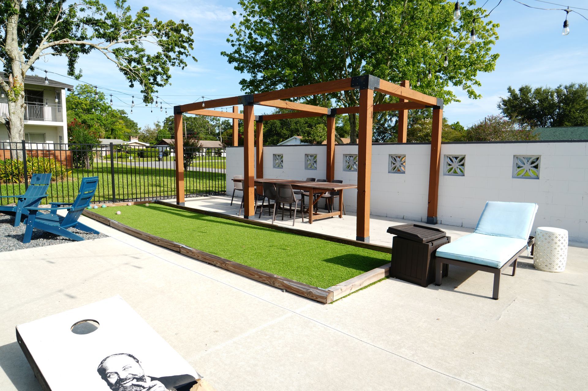 A patio with a pergola , chairs , and a table