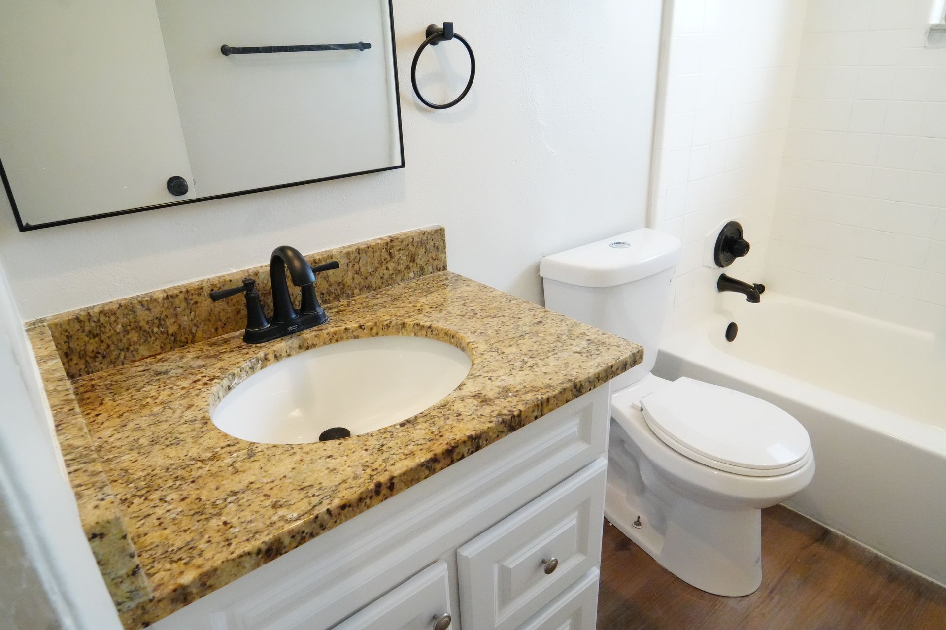 A bathroom with a sink , toilet and bathtub