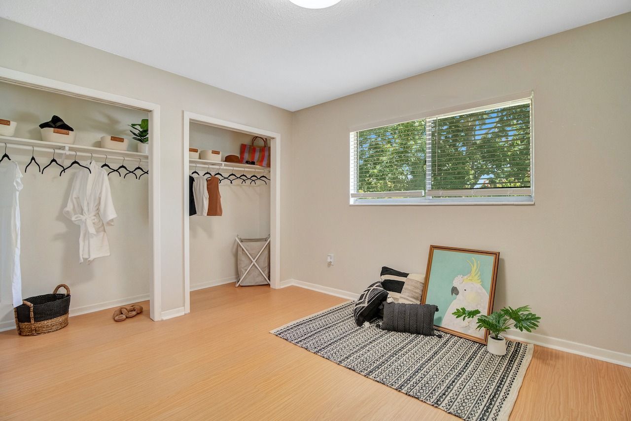 A bedroom with two walk in closets and a rug.