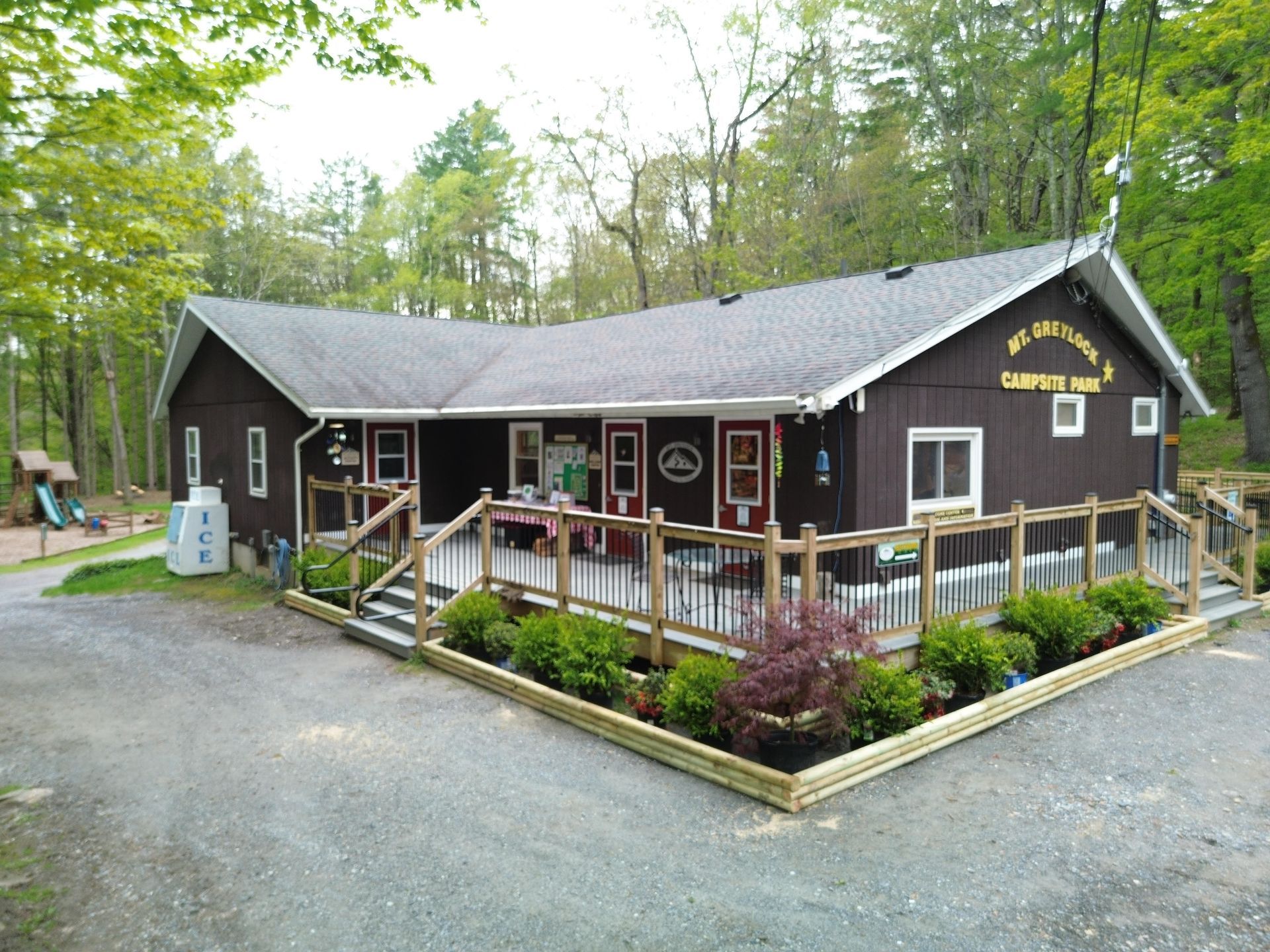 A man riding a bike in front of a house in the woods