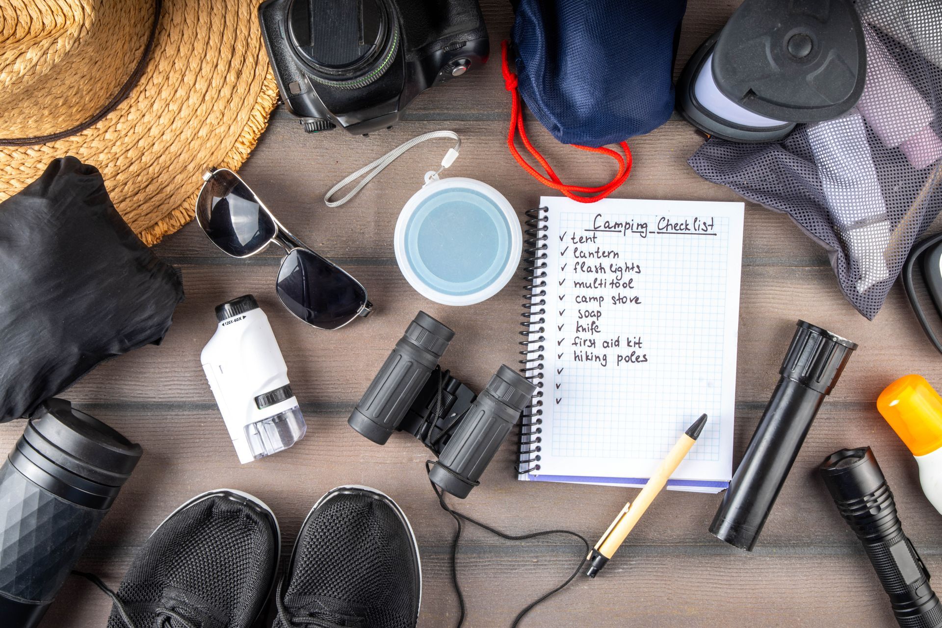 camping checklist surrounded by camping supplies