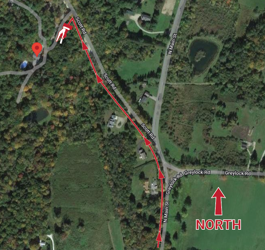 an aerial view of a road with a red arrow pointing to the north .