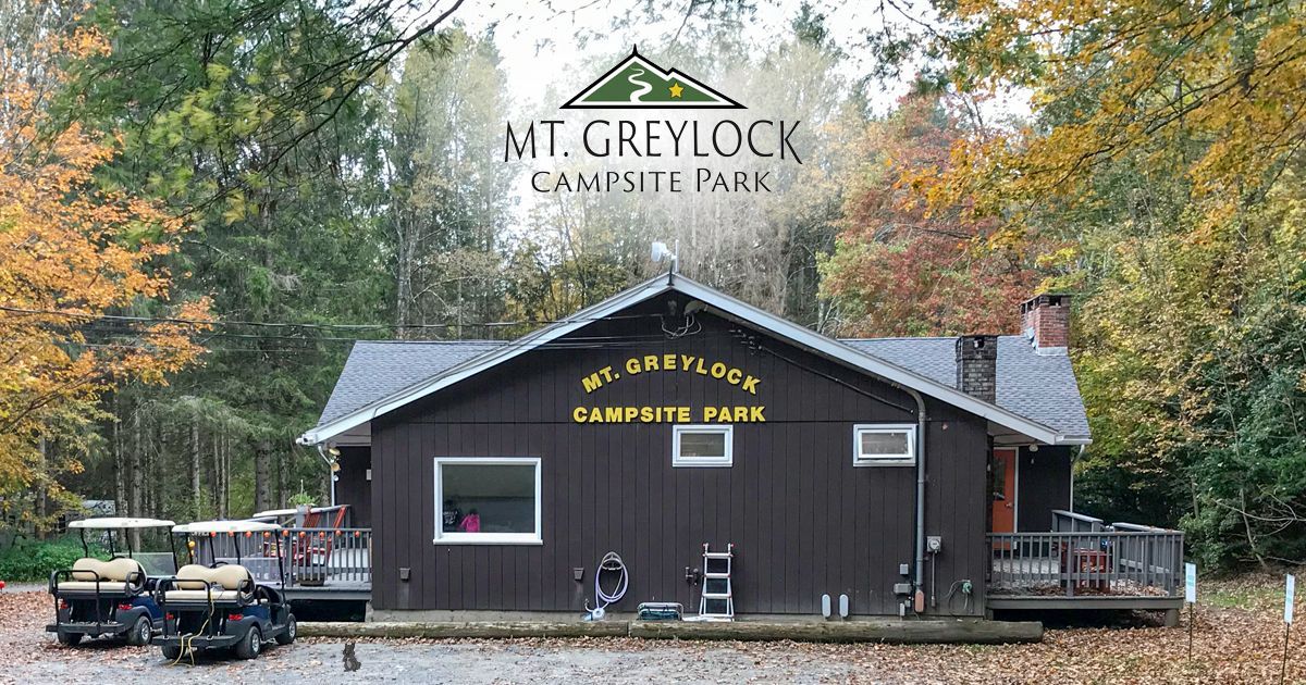 A campground activitiy center with a golf cart parked in front of it