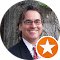 a man in a suit and tie is smiling in a circle with an orange star .
