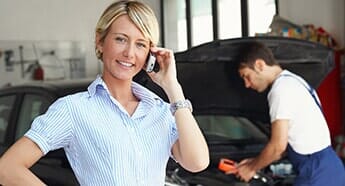 Woman Taking a call in automotive shop — Auto repair in  West Chester, PA