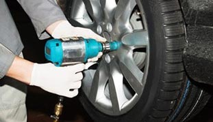 Man fixing tire — Safety Inspection in West Chester, PA