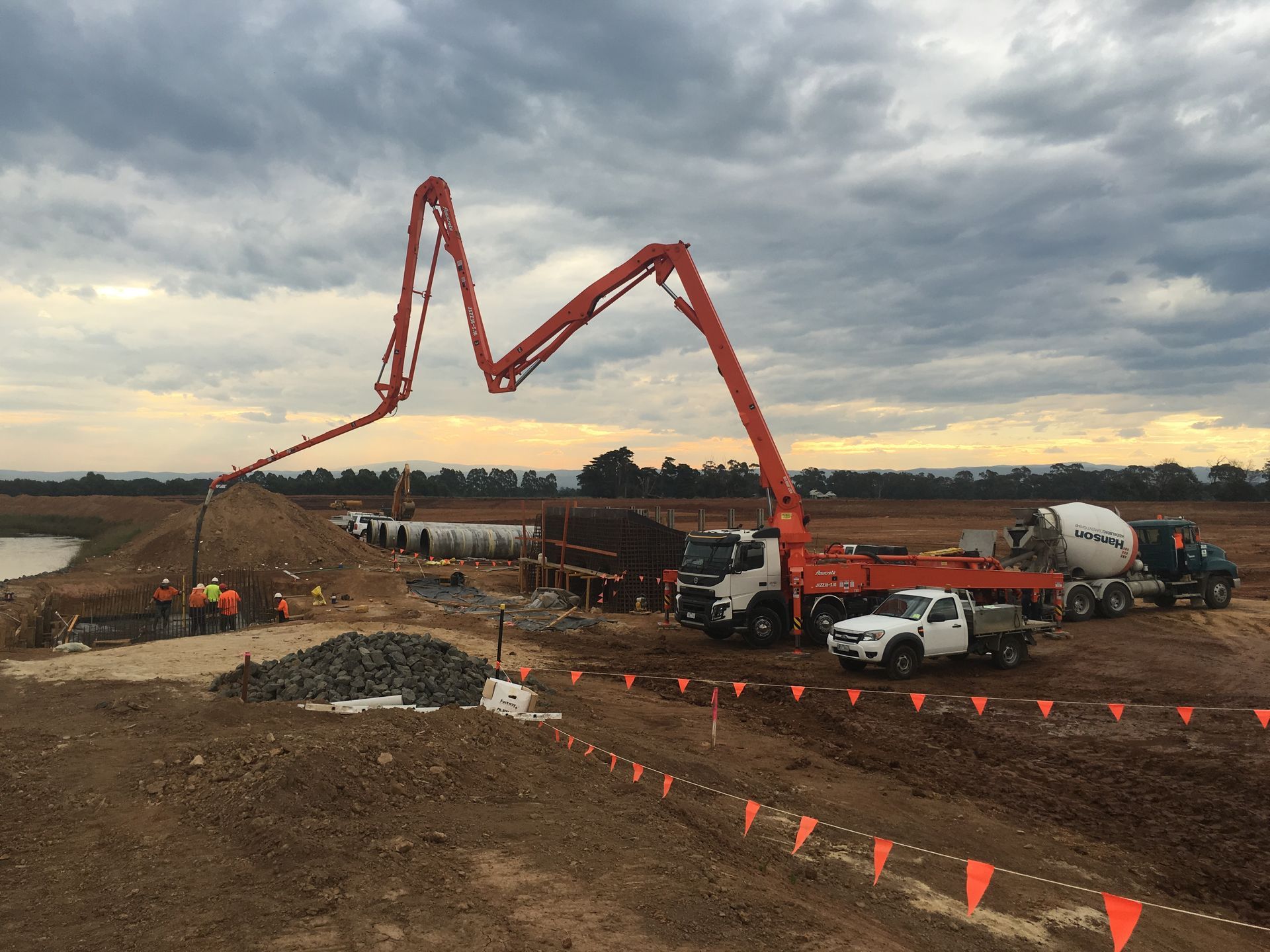 A concrete pump is being used to pump concrete on a construction site.