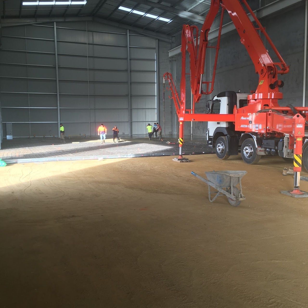A large red truck is parked inside of a building