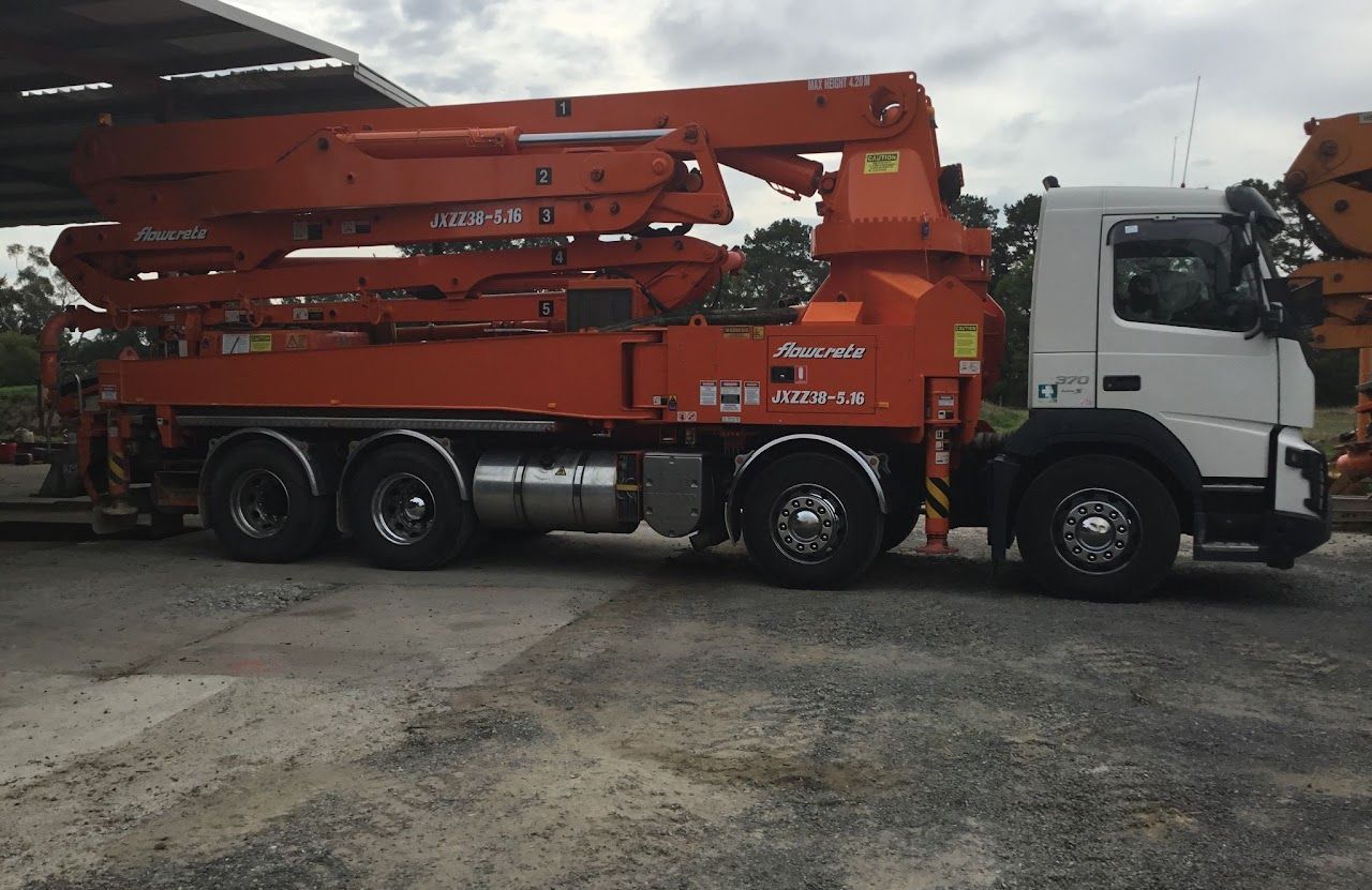 A concrete pump truck is parked in a parking lot.