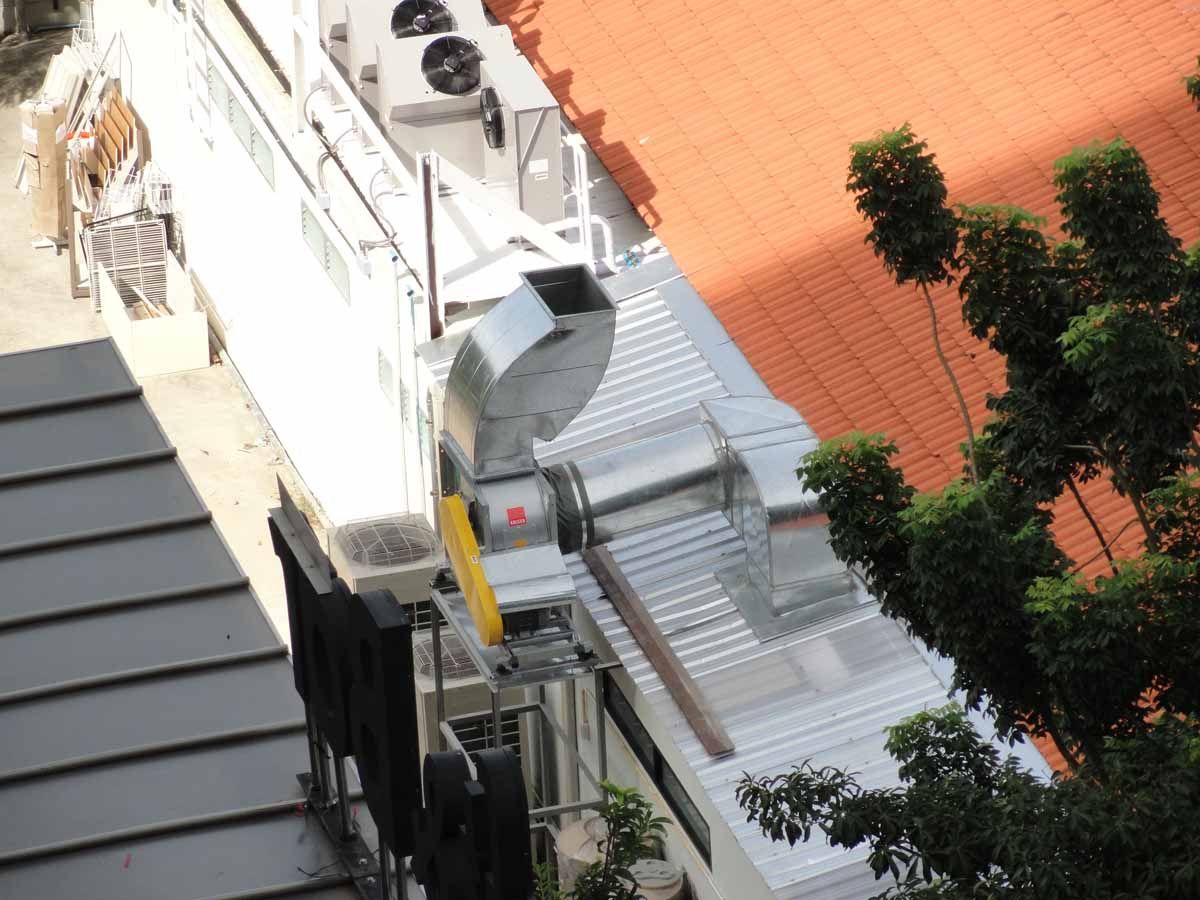 An aerial view of a building with a red roof