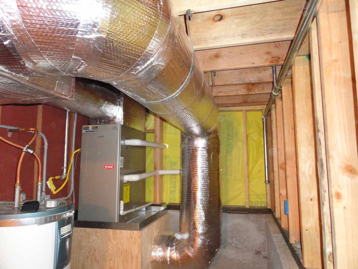 A room with a furnace and a water heater in it