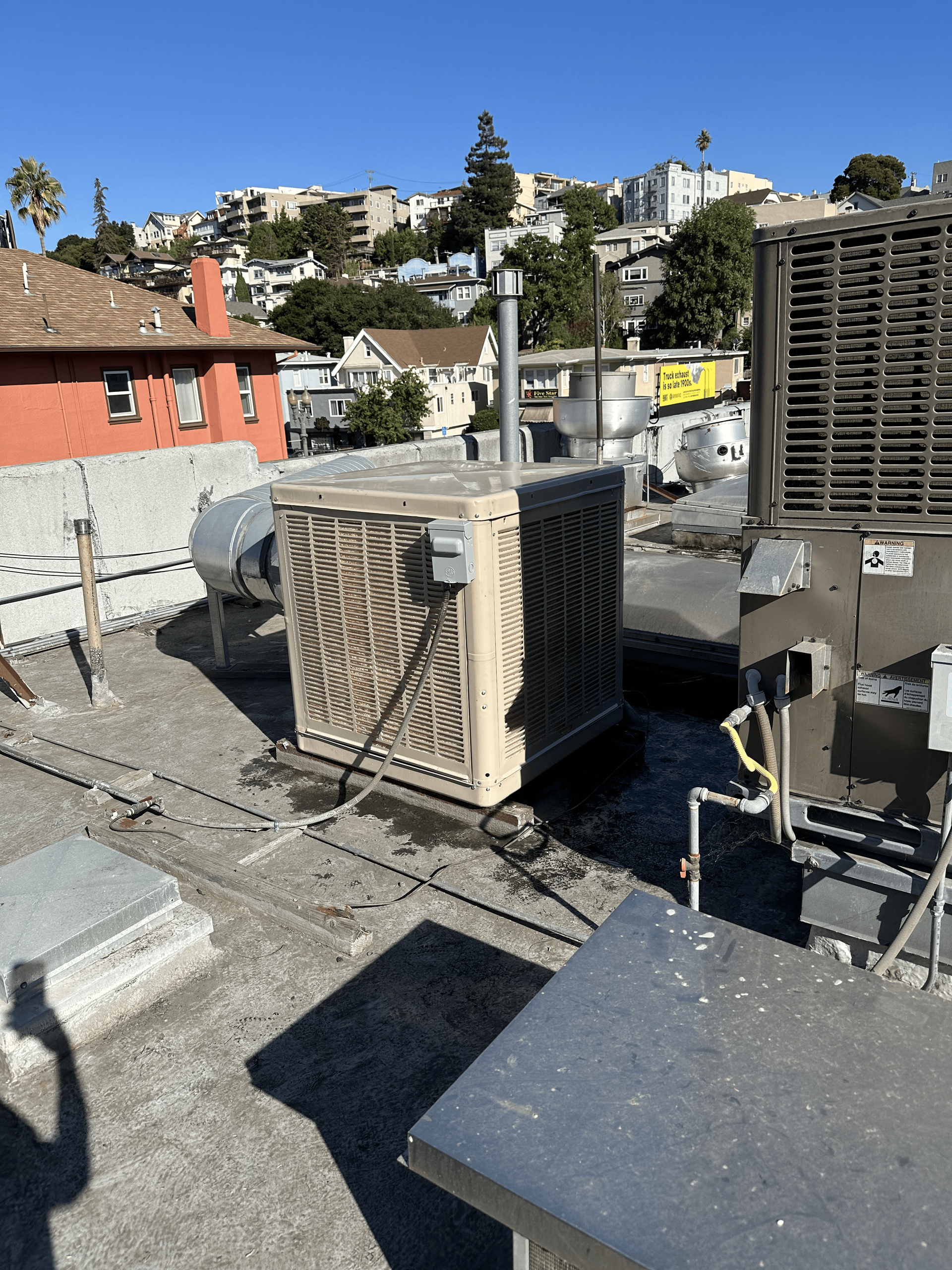 A rooftop with a lot of air conditioners on it