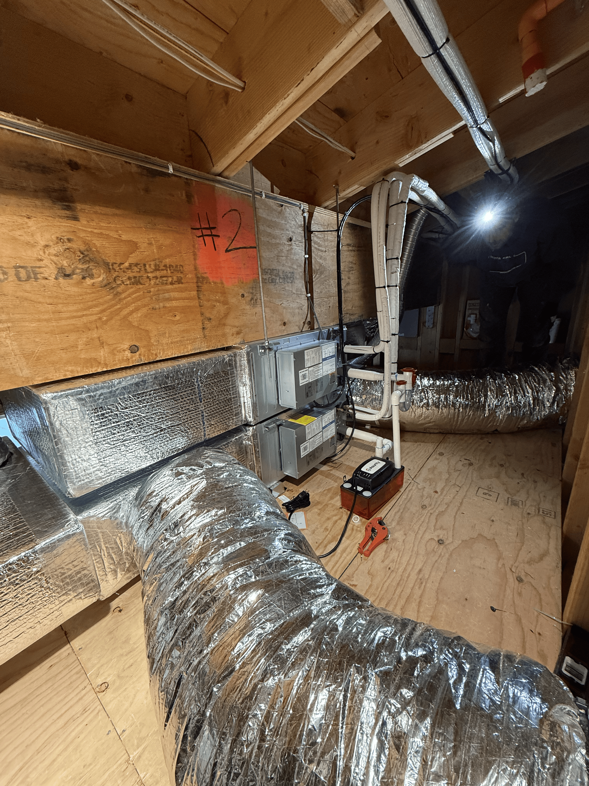 A room with a lot of ducts and pipes in it.