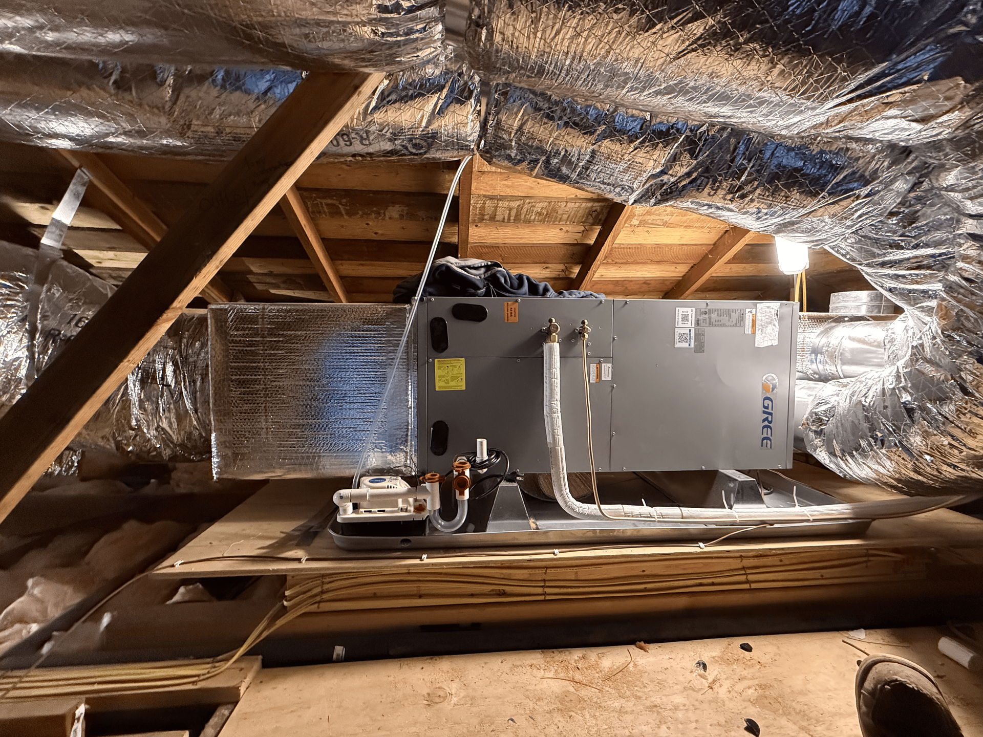 An air conditioner is installed in the attic of a house.