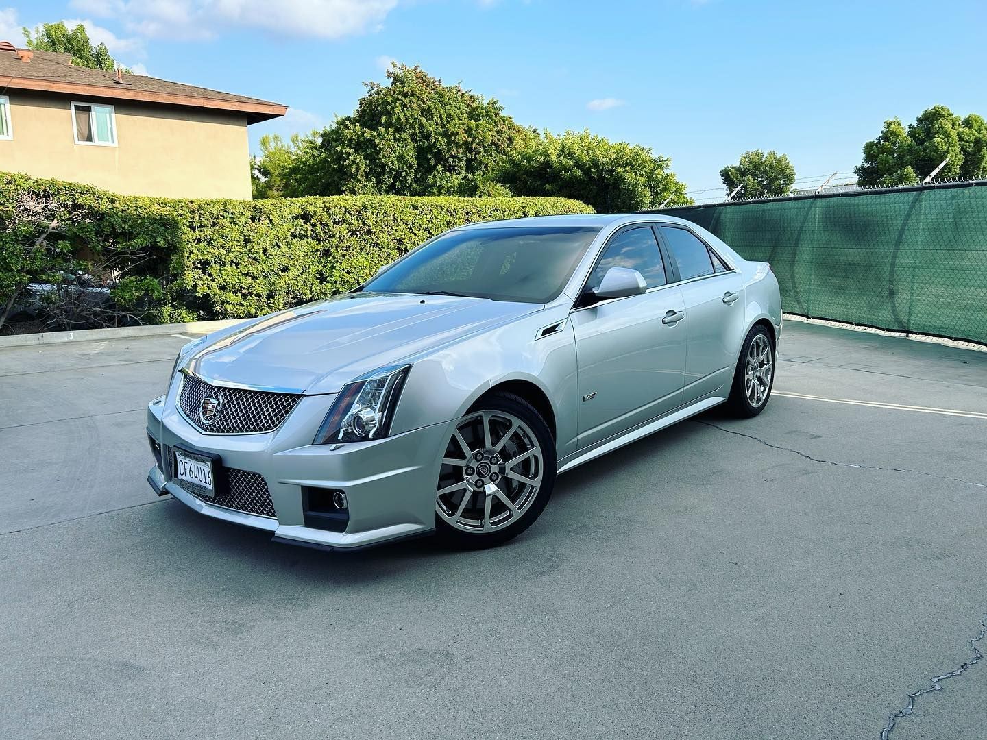 Silver Cadillac CTS-V sedan parked on asphalt, sunny day.