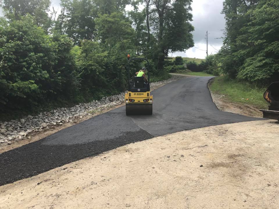 Asphalt Paving Repairs — Man in Asphalt Roller in Zanesville, OH